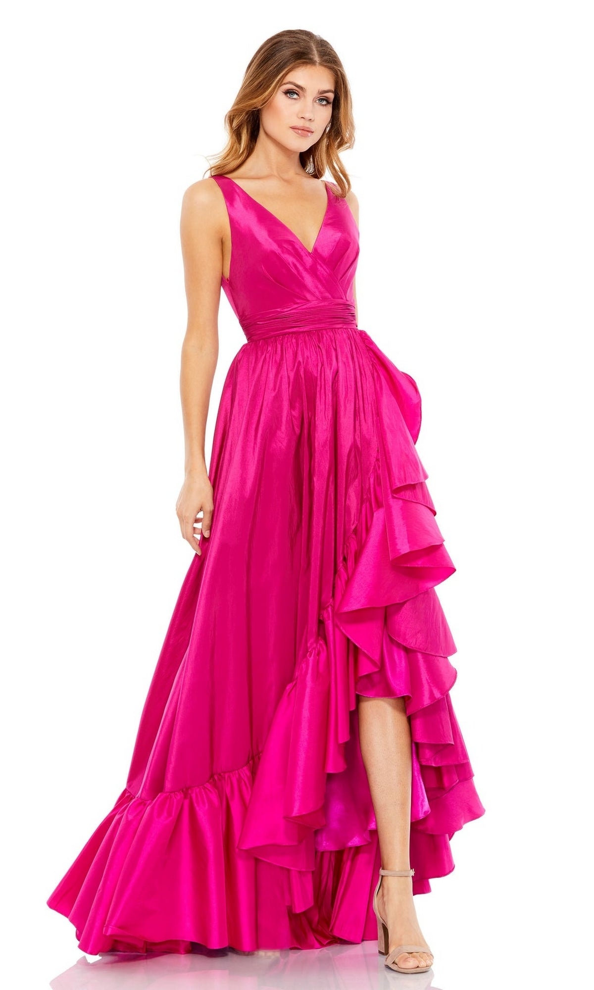A woman in the Mac Duggal 67835 long ruffled formal dress, featuring a sleeveless V-neck and floor-length hot pink design, stands against a white background wearing high-heeled sandals.
